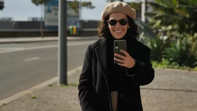 女人在街上用智能手机拍摄视频素材